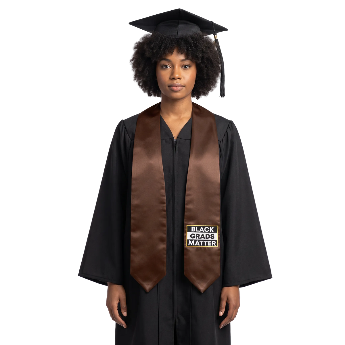 Brown graduation stole with pointed ends and a black-and-white BLACK GRADS MATTER patch with a gold border on one side.
