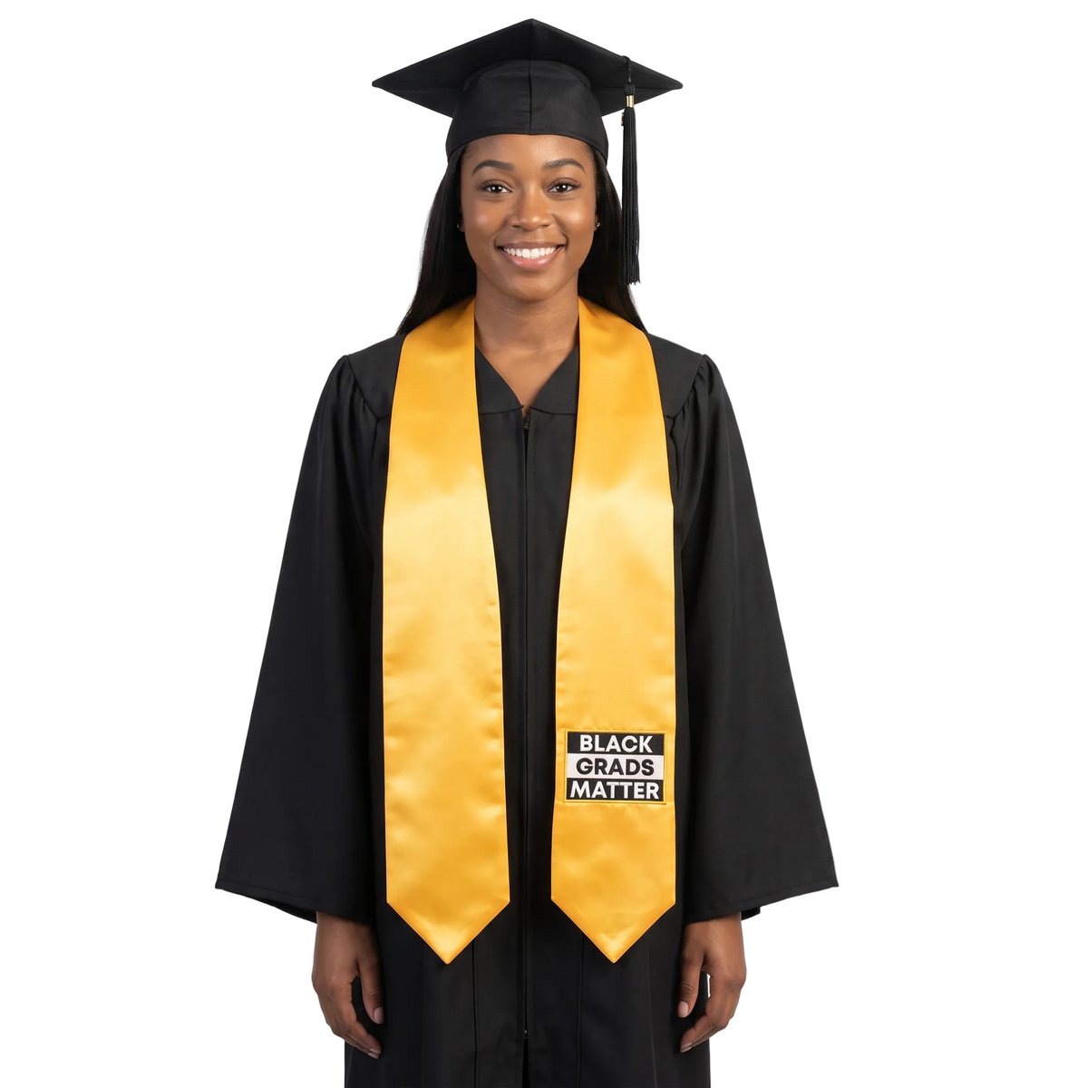Gold graduation stole with pointed ends and a black-and-white BLACK GRADS MATTER patch with a gold border on one side.
